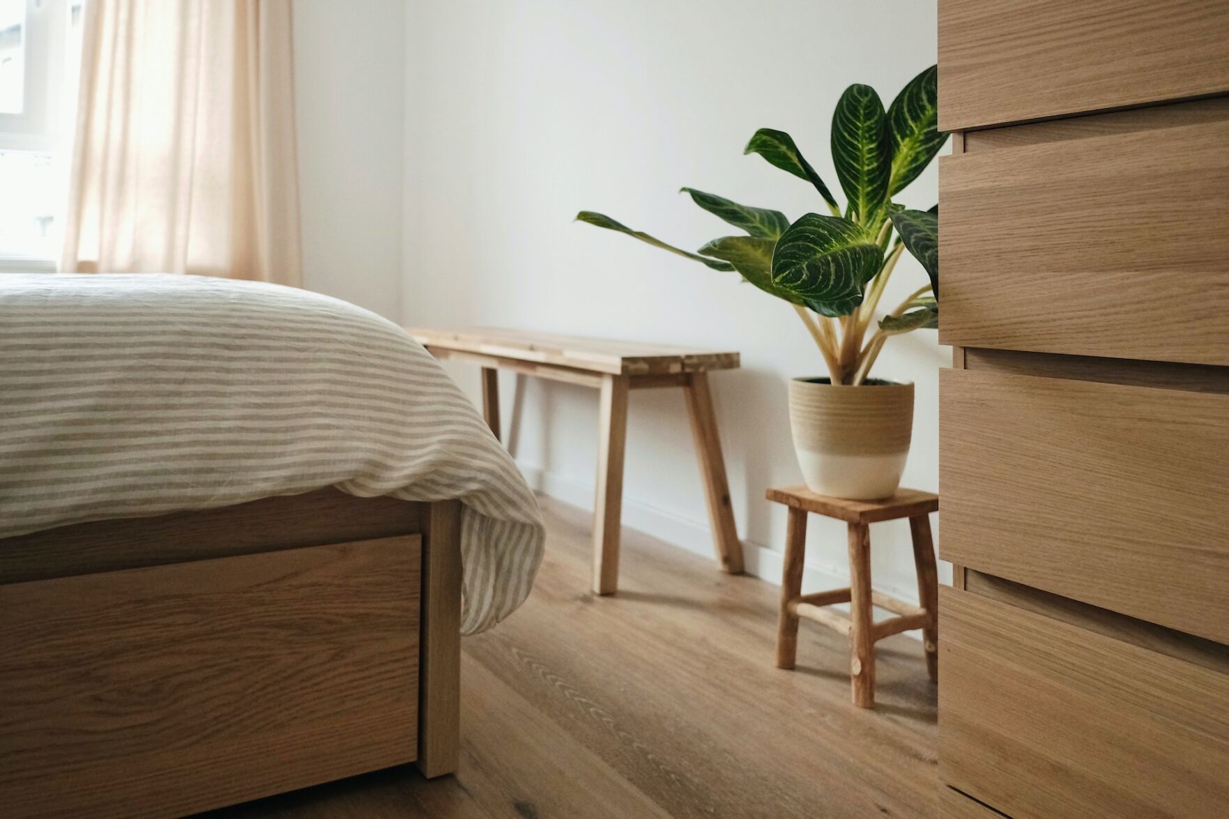 Room with a wide range of wood, including the bedframe, floor, and furniture